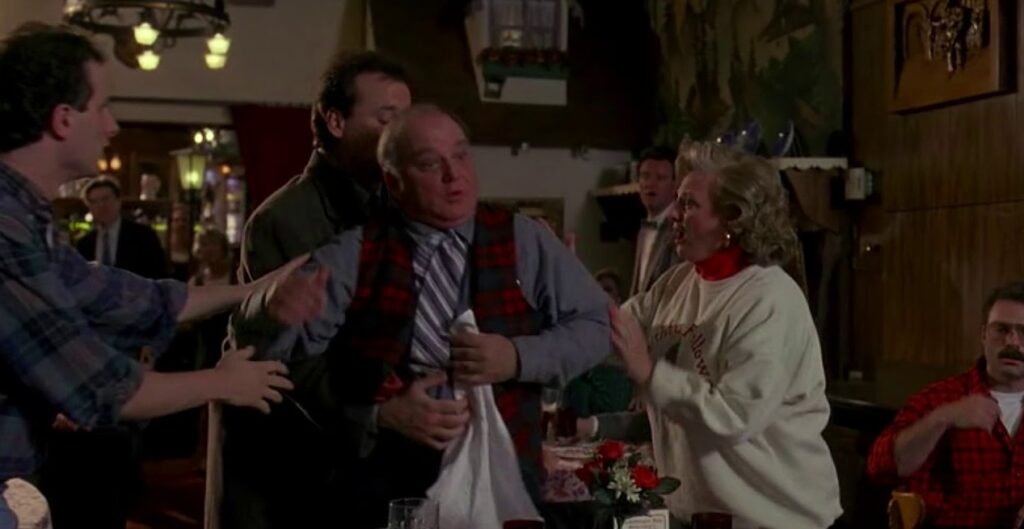 What to Do If Someone Is Choking: The Heimlich Maneuver Can Save a Life. Scene from the movie 'Groundhog Day'. What to Do If Someone Is Choking: The Heimlich Maneuver Can Save a Life. Scene from the movie 'Groundhog Day'. Photo.