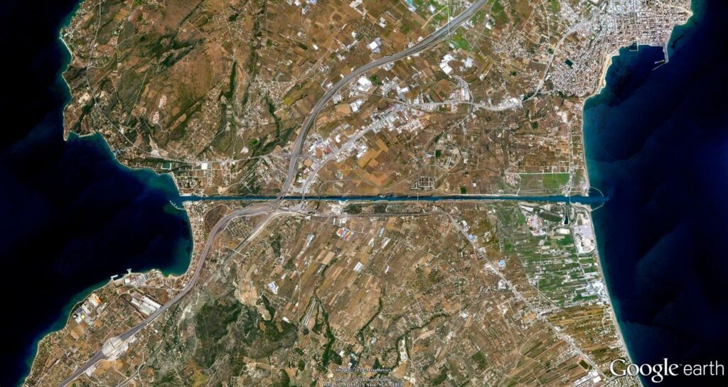 When Construction of the Corinth Canal Began and Why It Was Needed. A lock-free navigable canal in Greece connecting the Saronic Gulf of the Aegean Sea and the Gulf of Corinth of the Ionian Sea. Cut through the Isthmus of Corinth, connecting the Peloponnese peninsula with the central part of Greece. Image source: ca.pinterest.com. When Construction of the Corinth Canal Began and Why It Was Needed. A lock-free navigable canal in Greece connecting the Saronic Gulf of the Aegean Sea and the Gulf of Corinth of the Ionian Sea. Cut through the Isthmus of Corinth, connecting the Peloponnese peninsula with the central part of Greece. Image source: ca.pinterest.com. Photo.
