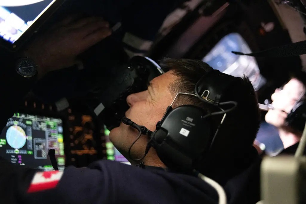 Astronaut Jeremy Hansen takes photos through the window of the Orion spacecraft at the start of the Artemis II lunar flyby mission. Hansen and his crewmates spent about seven hours taking turns capturing scientific data through Orion's windows to share with their team on Earth.