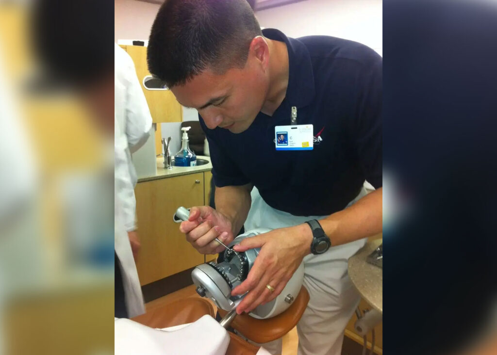 An astronaut practices extracting a tooth on a training model. Photo.