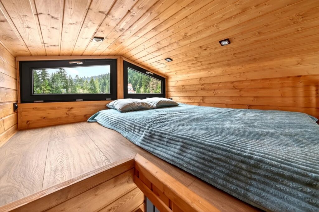 The first bedroom above the bathroom. A folding ladder leads to the second bedroom and folds against the wall. Image source: craft-house.eu. Photo.