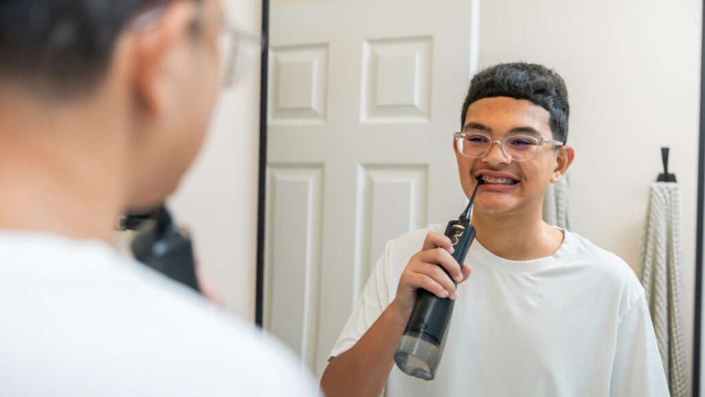 A water flosser directs a thin stream of water into interdental spaces and is believed to protect against cavities. Photo.