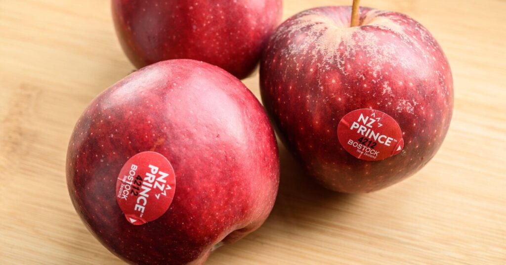 PLU code on an apple in a supermarket, a small sticker with big information. Image source: mashed.com. Photo.