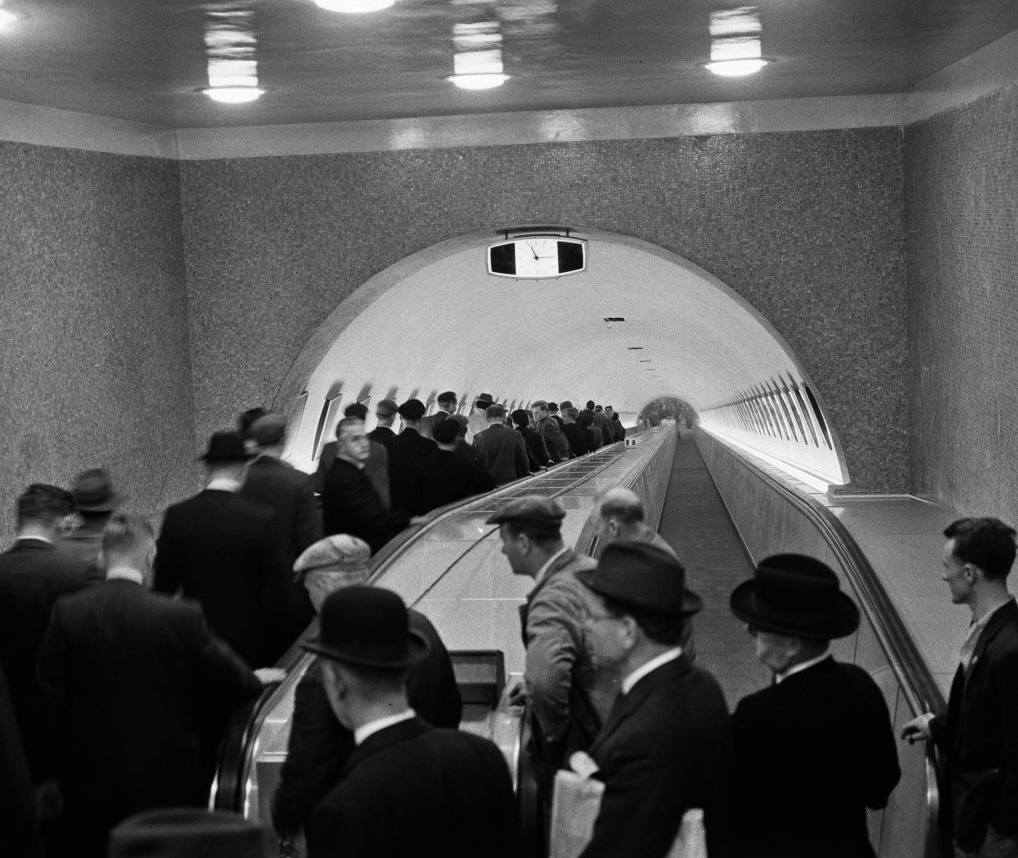 On October 8, 1960, passengers use the newly installed Trav-O-Lator moving sidewalk at Bank station on the London Underground.