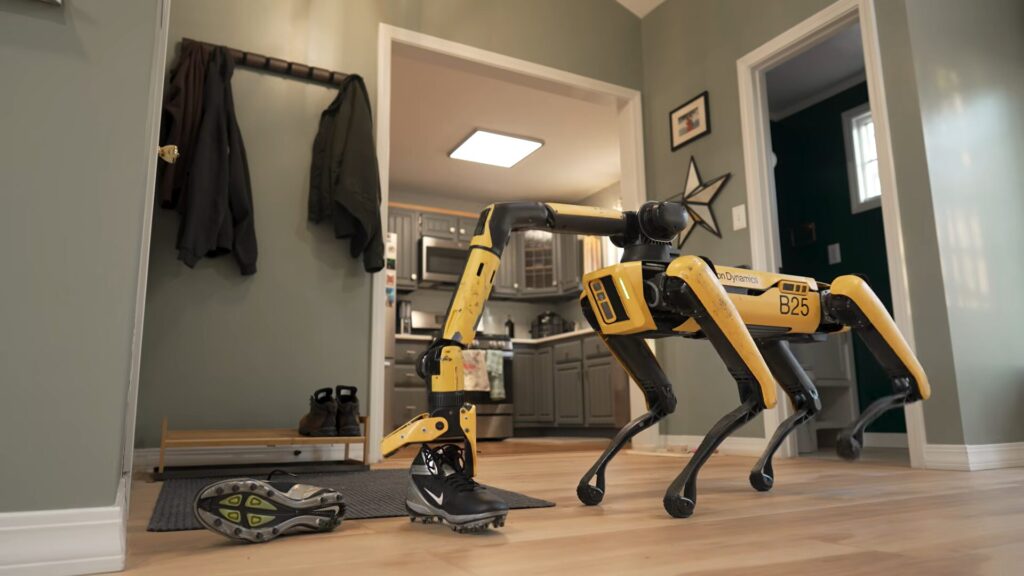 Boston Dynamics' Spot robot cleans up following instructions written on a whiteboard. Photo.