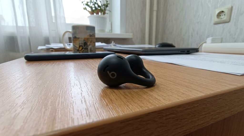 Baseus ear cuff headphones — I run in these instead of AirPods. Ears are open, music is playing, I can hear a car at the intersection — exactly what you need for a run. Photo.