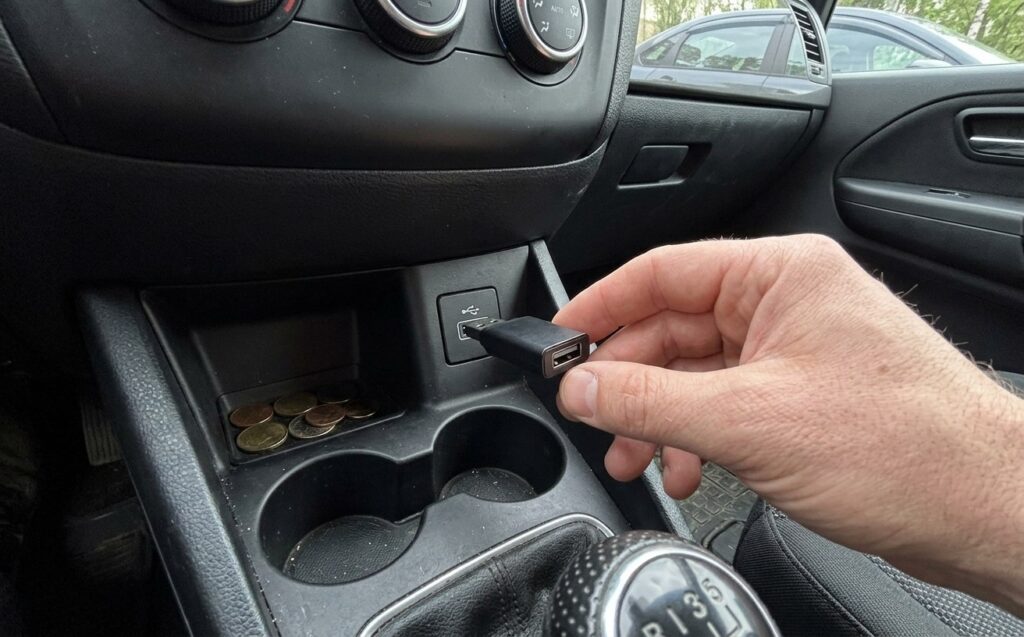 Wireless CarPlay adapter — I stopped plugging in a cable every time. Plugged it into USB once — and haven't touched cables since. Photo.