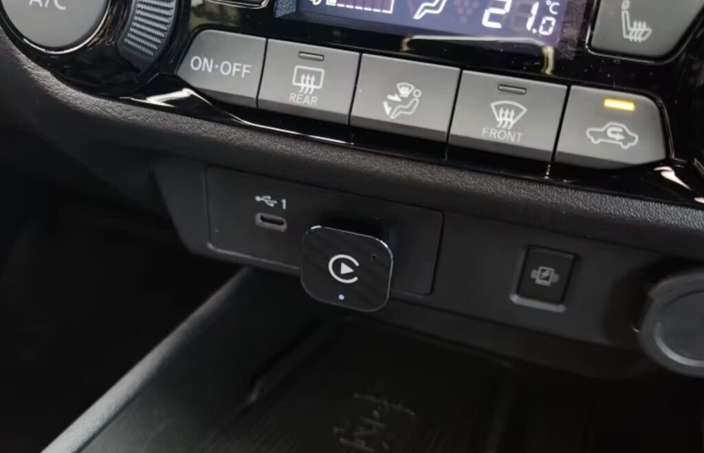 Best CarPlay adapter for iPhone: what to look for before buying. You can buy a very compact adapter that will be barely visible. Photo.