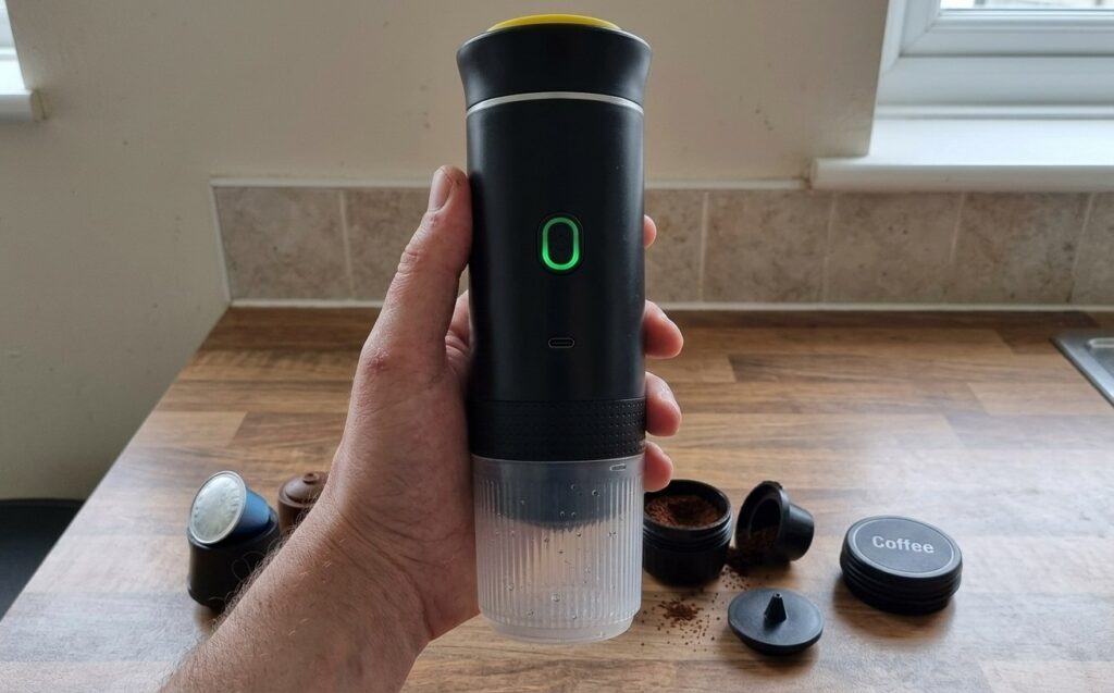 Compact capsule coffee machine for travel. The coffee machine works with any of three capsule types. Photo.