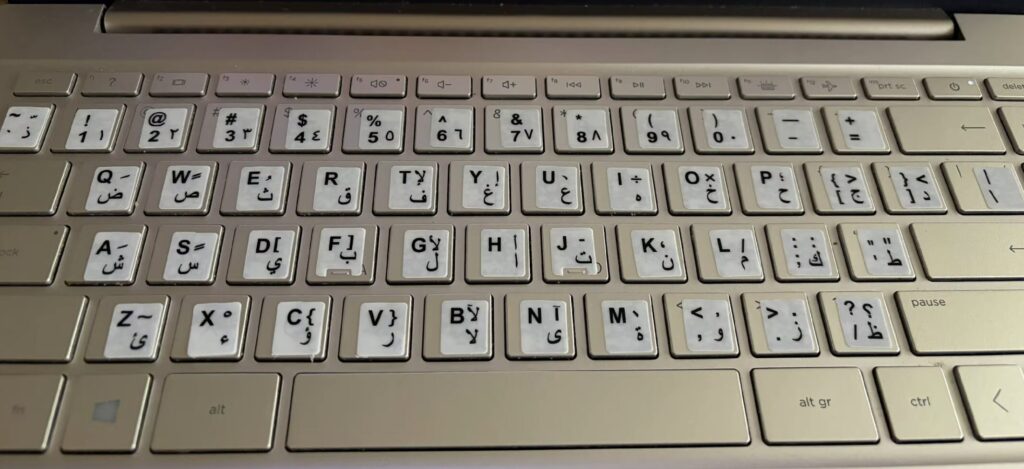 Engraving, stickers, or key replacement: what's best for a MacBook. Stickers on the keyboard look completely out of place. Photo.
