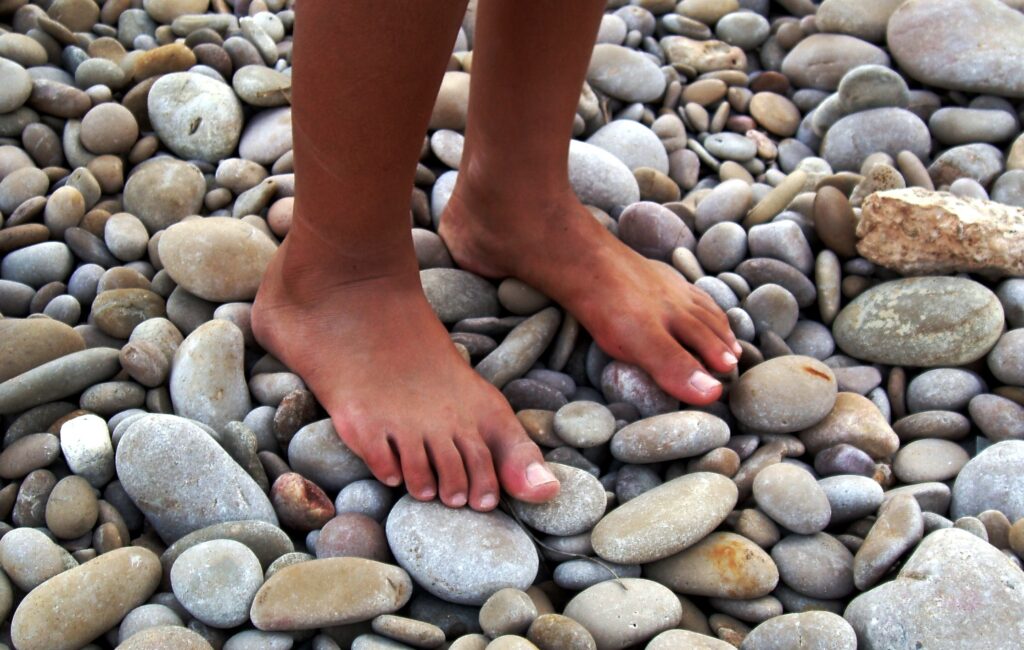 Walking on pebbles — a free massage and workout for your feet. Photo.
