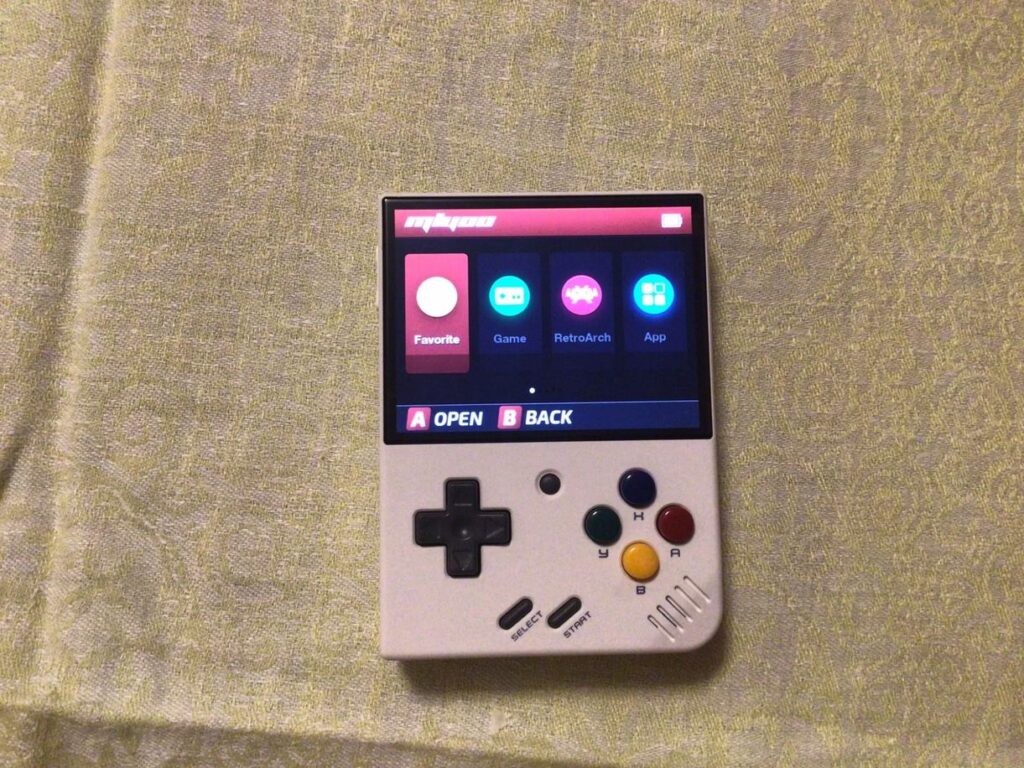 Portable gaming console for emulators and retro games. The best retro console is available at a good price only on AliExpress. Photo.