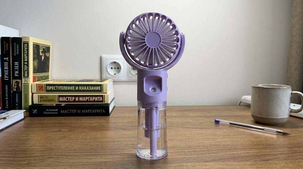Portable fan with mist sprayer — saved me on the balcony. Standing on the balcony at +35°C, blowing fine water mist in my face — and life became bearable. Photo.