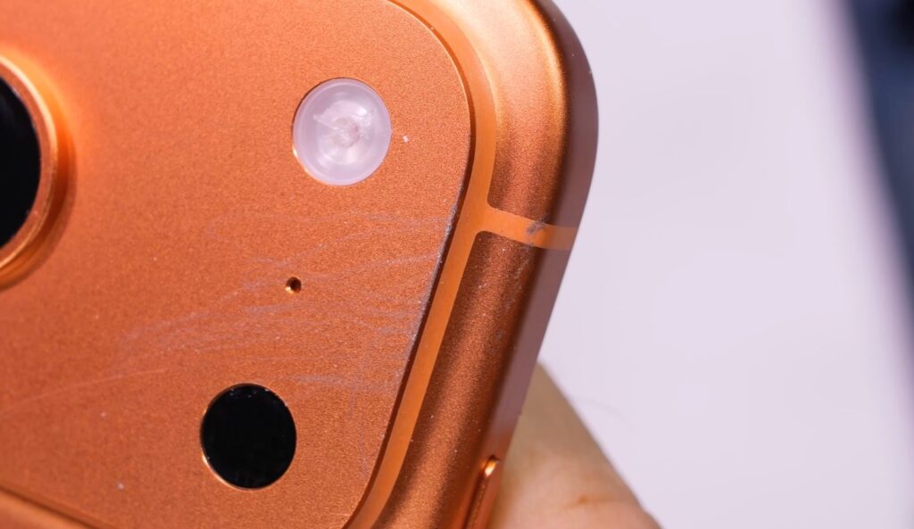 Why the aluminum iPhone body scratches easily. Scratches are especially visible on the camera module. Photo.