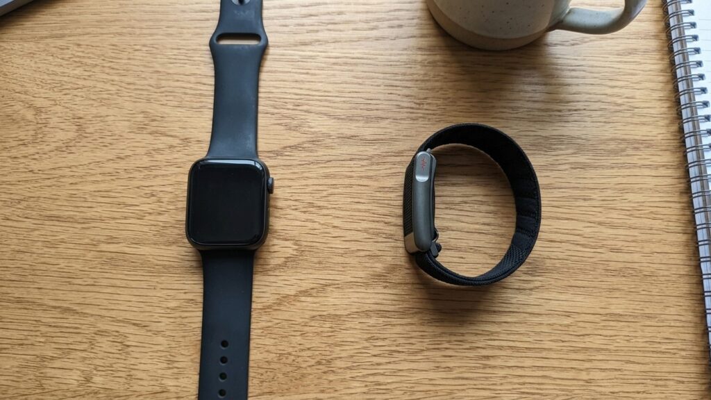 Apple Watch and Whoop LOOP copy on an oak table