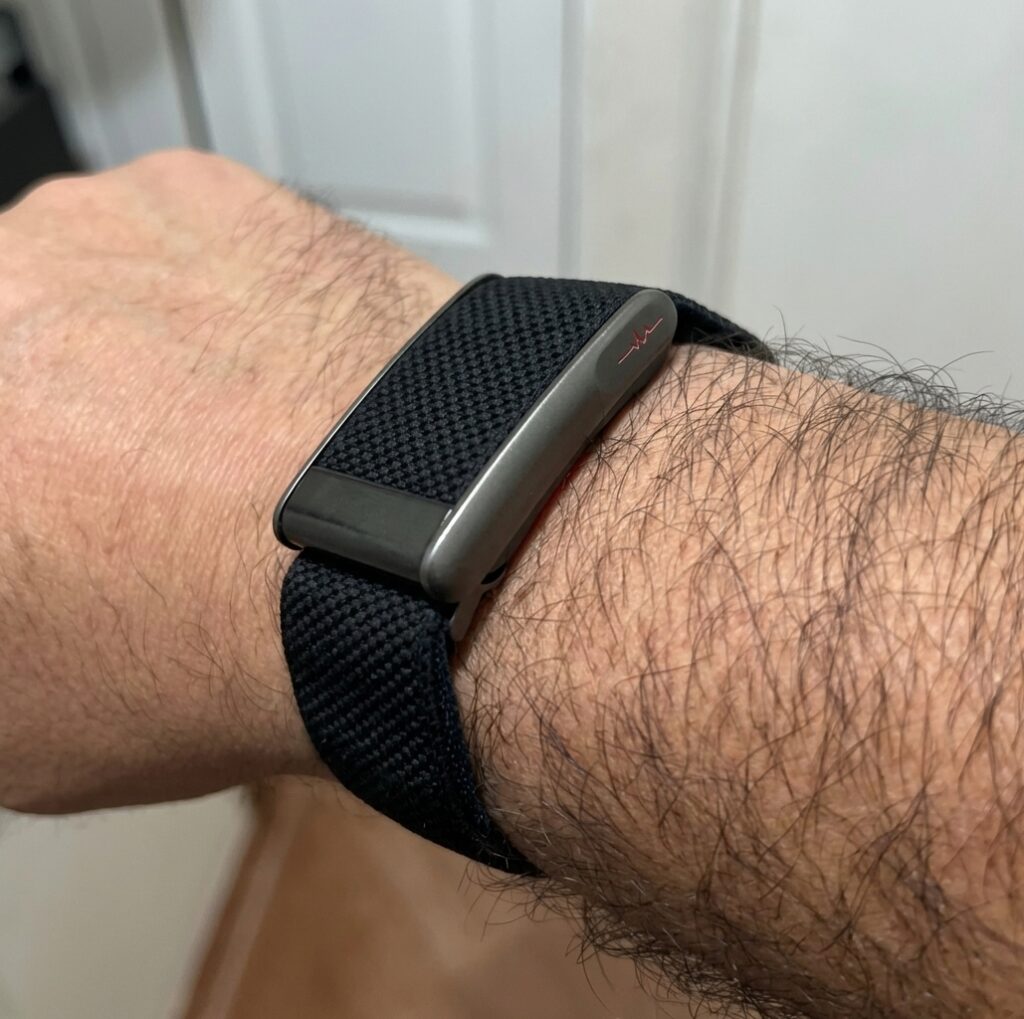 Whoop LOOP copy in profile on the wrist — flat metal module