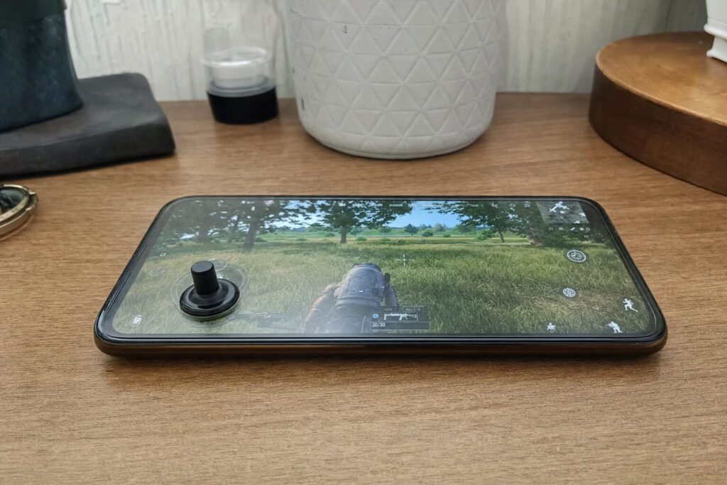 Mini suction-cup joystick attached to a phone screen