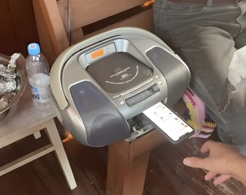 The phone must be positioned speaker-down on the tape transport mechanism.