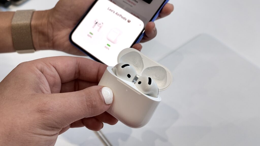 AirPods 5 in their case during quick pairing with an iPhone