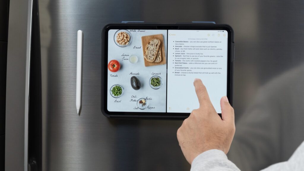 A recipe on the screen of an iPad attached magnetically to a fridge