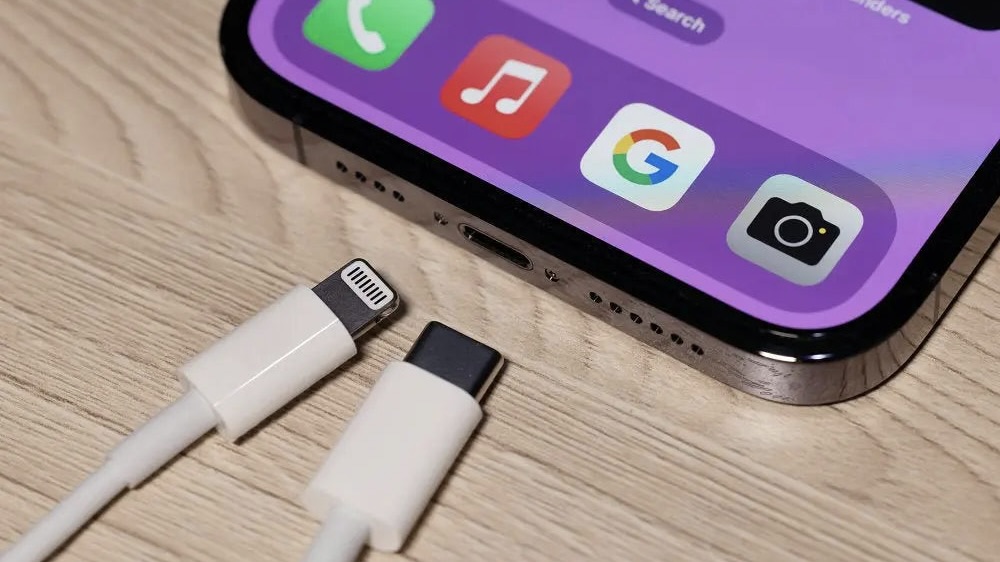Lightning and USB-C cables next to an iPhone