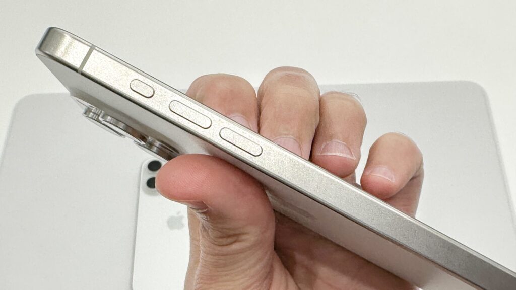 The Action button and volume keys on the side of an iPhone